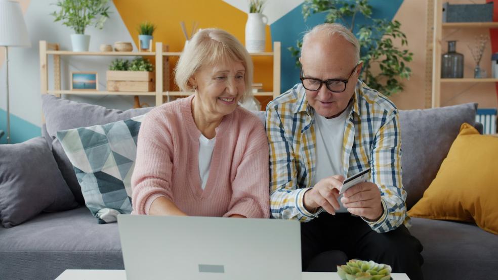 Couple calculating household bills Couple calculating household bills