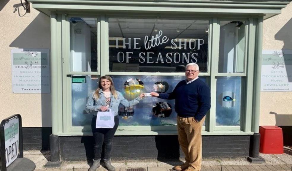 Competition winner, Hollie Broom with Roger Hemming from Roger Hemming Estate Agents, outside The Little Shop of Seasons in Honiton.